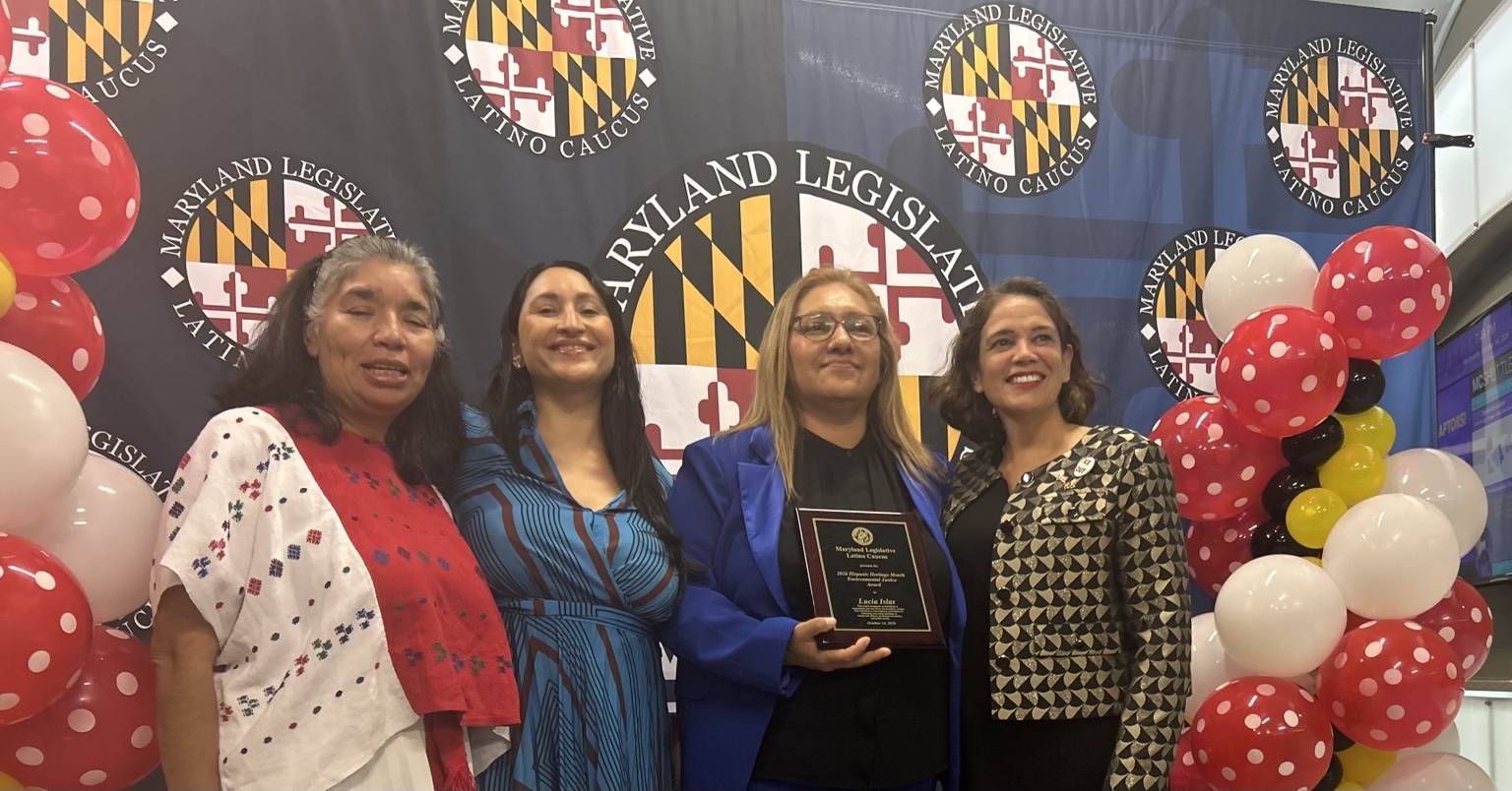 Group photo at the Maryland Legislative Latino Caucus awards celebration, with an honoree holding an award plaque.